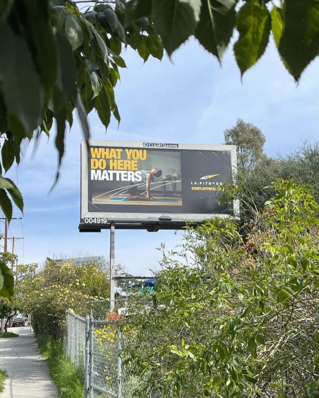 LA Fitness Billboard featuring an image by Caleb Kuhl of a man and a woman in a yoga class